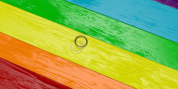 Ring jewelry couple proud pride male female lady gender\
marriage engagement marriage couple romantic rainbow colorful\
background wallpaper copy space symbol girlfriend boyfriend\
wedding3d render