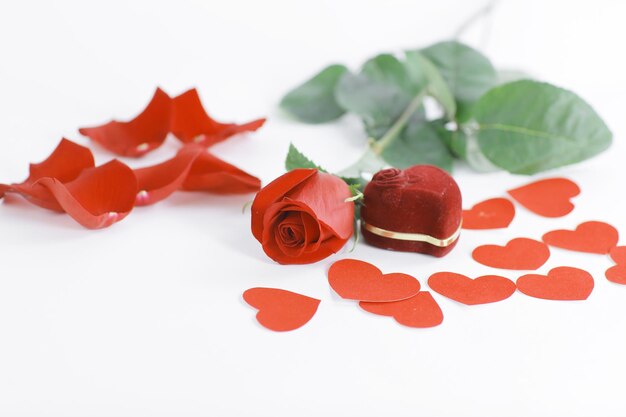 Ring in red box with a red rose on the white background