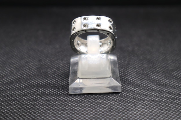 a ring with a diamond ring on it is on a black surface