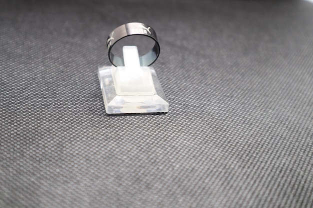 a ring with the number 4 on it is on a black cloth