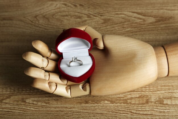 Photo ring in wooden hand on white