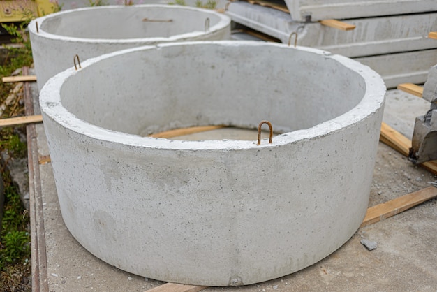 Rings of reinforced concrete wells lie in the warehouse of the plant.
