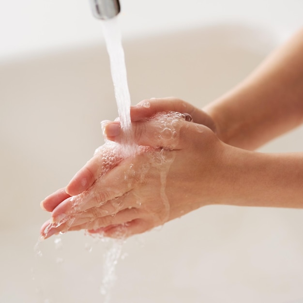 Rinse while rubbing Cropped shot of hands being washed at a tap