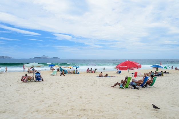 RIO DE JANEIRO - MARCH 3, 2014: People relax on Copacabana Beach is one of the most famous and crowded beaches in Rio de Janeiro, Brazil.