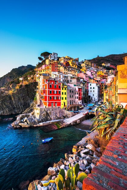 Riomaggiore town cape and sea landscape at sunset Cinque Terre Liguria Italy