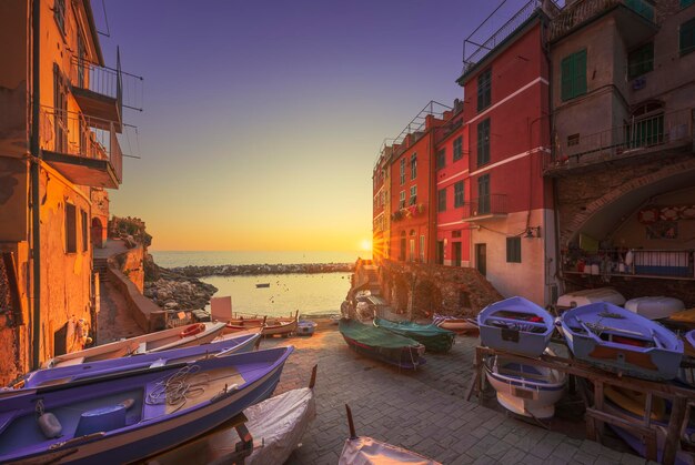 Riomaggiore village street boats and sea at sunset Cinque Terre Ligury Italy