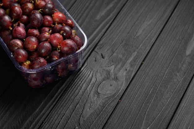 Ripe agrus or gooseberry on a dark wooden background