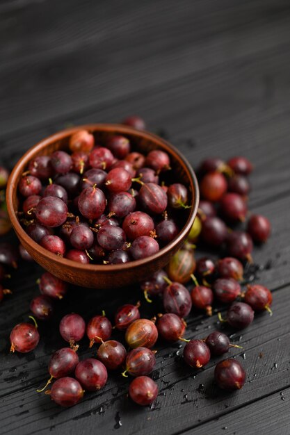 Ripe agrus or gooseberry on a dark wooden background