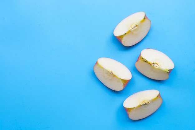 Ripe apple slices on blue