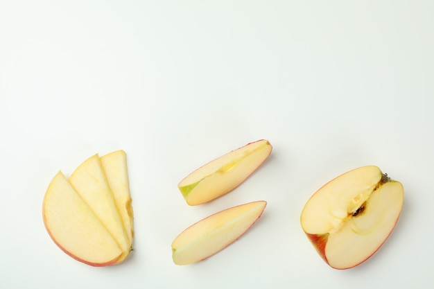 Ripe apple slices on white, top view