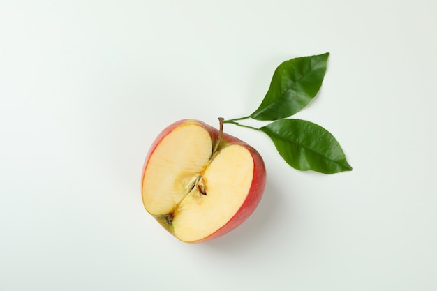 Ripe apple with leaves on white