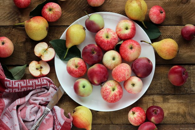 Ripe apples and pears on the table, top view. Table-still life.