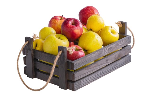 Ripe apples in a wooden box Red and yellow apples isolate Fruits healthy food