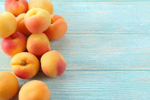 Ripe apricots on wooden table close up