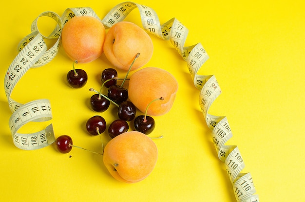 Ripe apricots on yellow wall