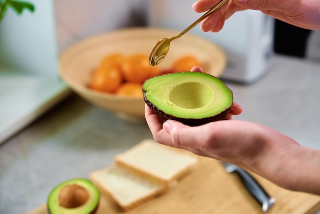 Ripe avocado in woman hands healthy breakfast