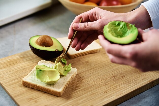 Ripe avocado in woman hands healthy breakfast