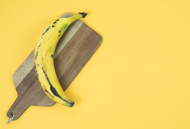 Ripe banana on a yellow background