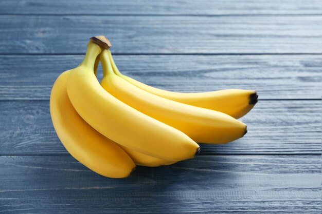 Ripe bananas on wooden background