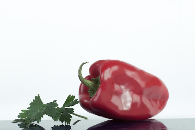 Ripe bell pepper and a sprig of parsley isolated on a white