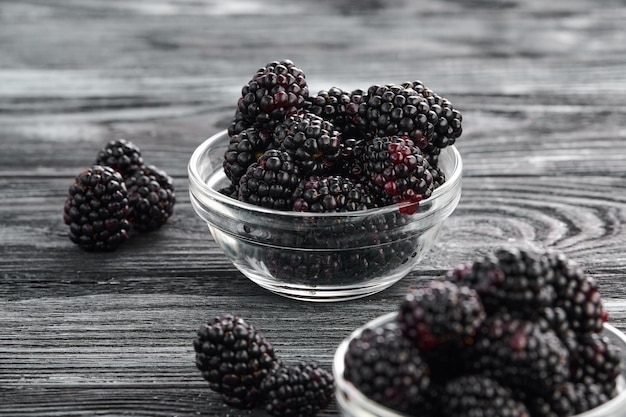 Ripe blackberries in bowls on the table