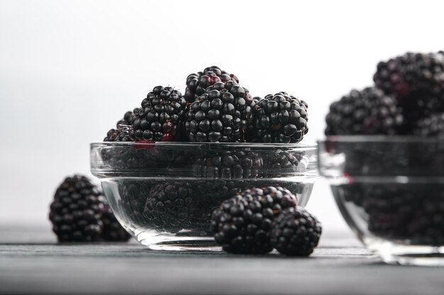 Ripe blackberries in bowls on the table