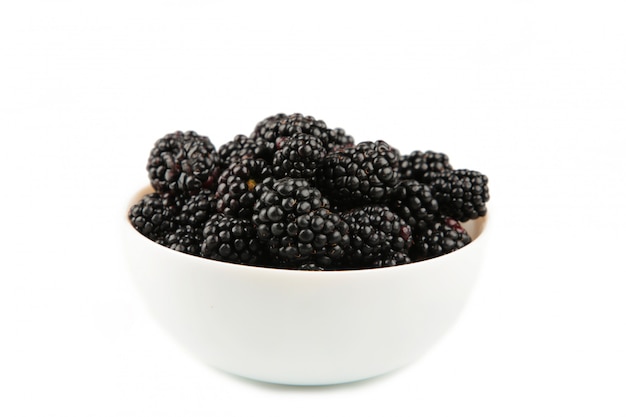 Ripe blackberries in a white bowl