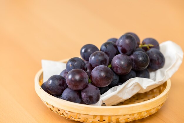 Ripe blue grape on the basket