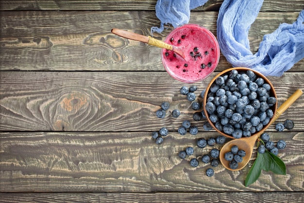 Ripe blueberries, in composition on an old background.