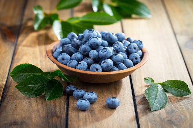 Ripe blueberries, in composition on an old surface.