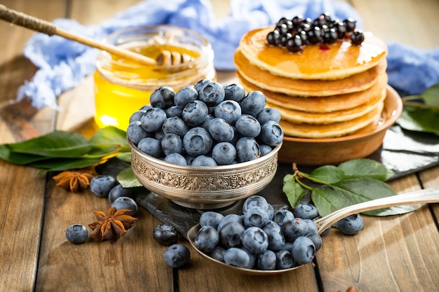 Ripe blueberries, in composition on an old surface.