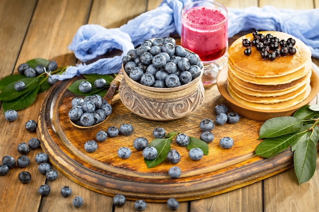 Ripe blueberries, in composition on an old surface.