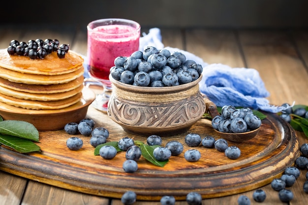 Ripe blueberries, in composition on an old surface.