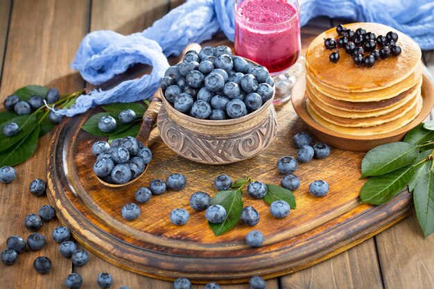 Ripe blueberries, in composition on an old surface.