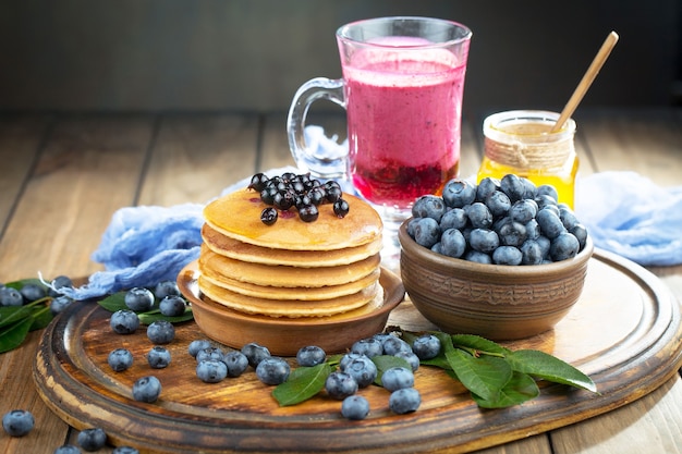 Ripe blueberries, in composition on an old surface.