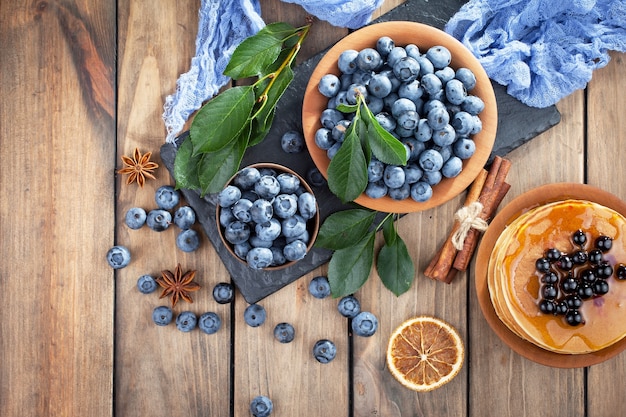 Ripe blueberries, in composition on an old surface.