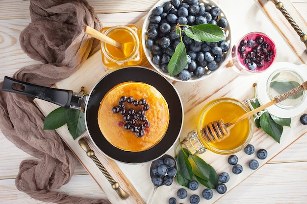 Ripe blueberries, in composition on an old surface.