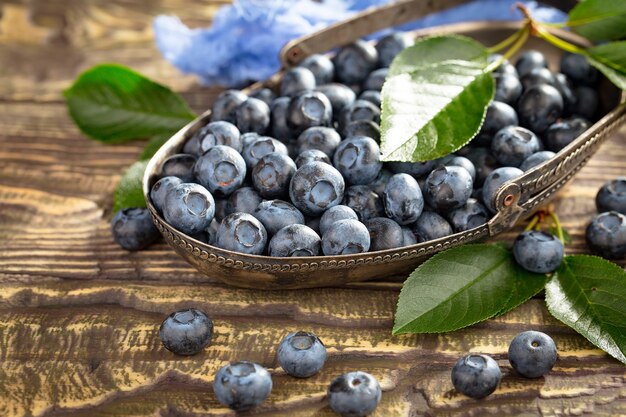 Ripe blueberries, in composition on an old surface.