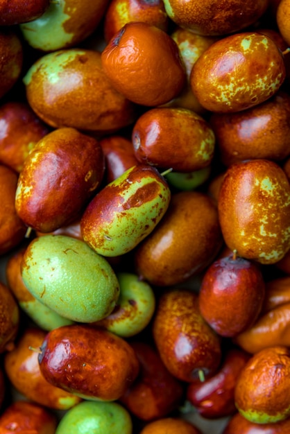 Photo ripe broun jujube chinese dates, close up.