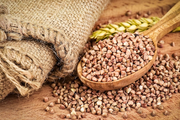 Ripe buckwheat grains in wooden spoon