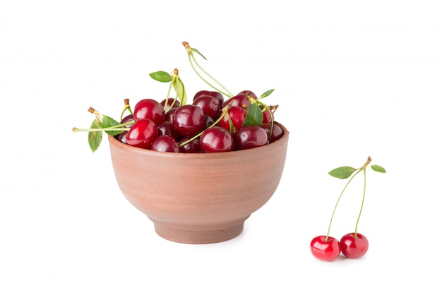 Ripe cherries in a bowl isolated on a white background