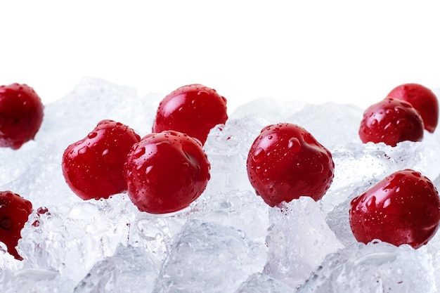 Ripe cherries covered with drops on ice cubes close up