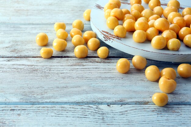 Ripe cherry-plums on wooden table close up