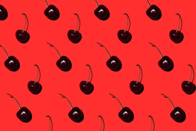 Ripe cherry on a red background Pattern