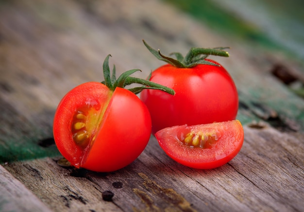 ripe cherry tomatoes on wooden table