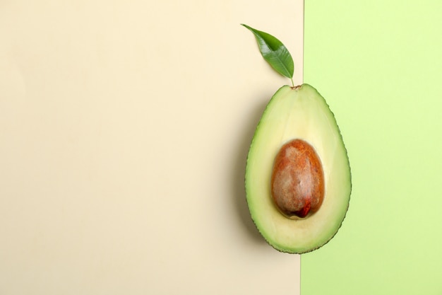 Ripe cut avocado on color