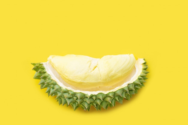 Ripe cut durian on yellow.