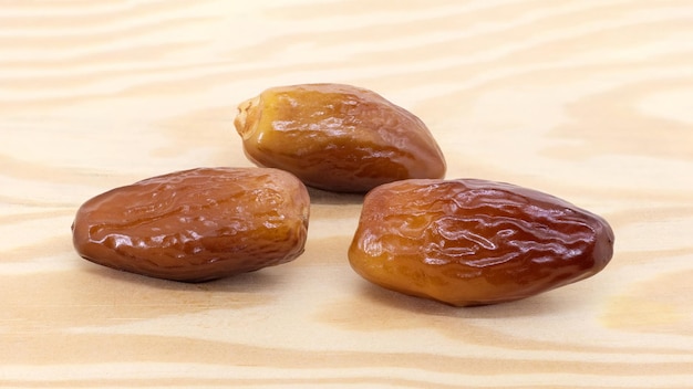 Ripe dates on a light wooden background