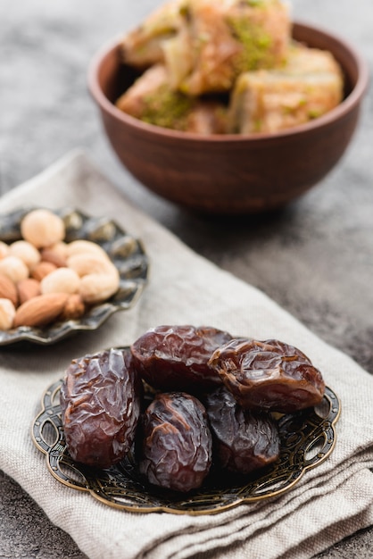 Photo ripe dates on metallic plate over the folded napkin