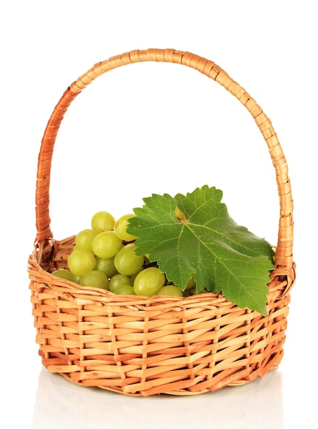 Ripe delicious grapes in wicker basket isolated on white